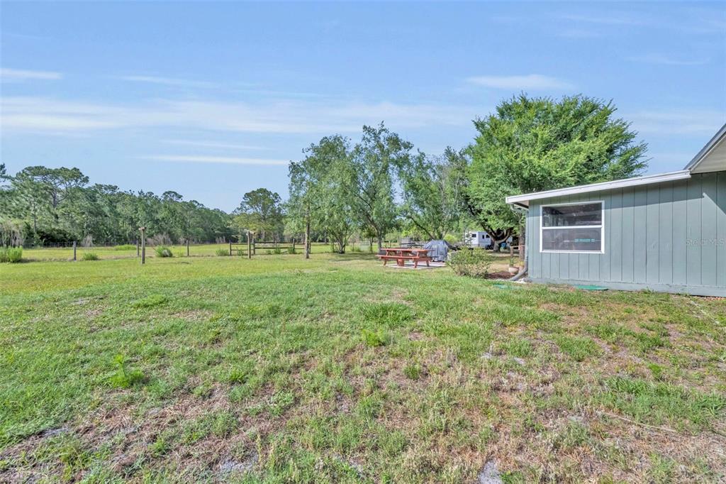 430 Cypress Isles Road Osteen, FL 32764 - Photo 28 of 55 a view of a backyard with a garden and plants