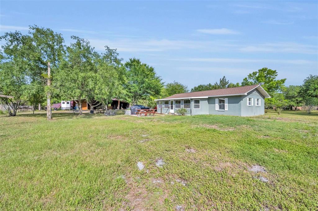 430 Cypress Isles Road Osteen, FL 32764 - Photo 29 of 55 a front view of house with yard and trees in the background