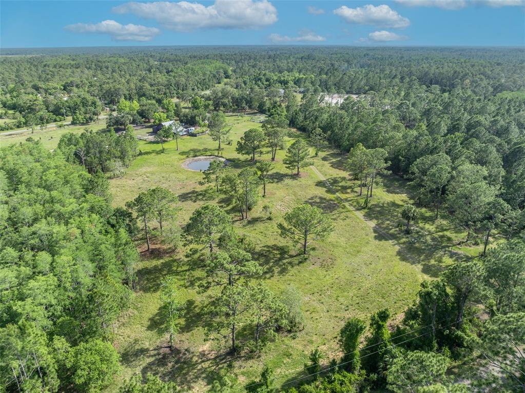 430 Cypress Isles Road Osteen, FL 32764 - Photo 46 of 55 a view of a green field with lots of trees