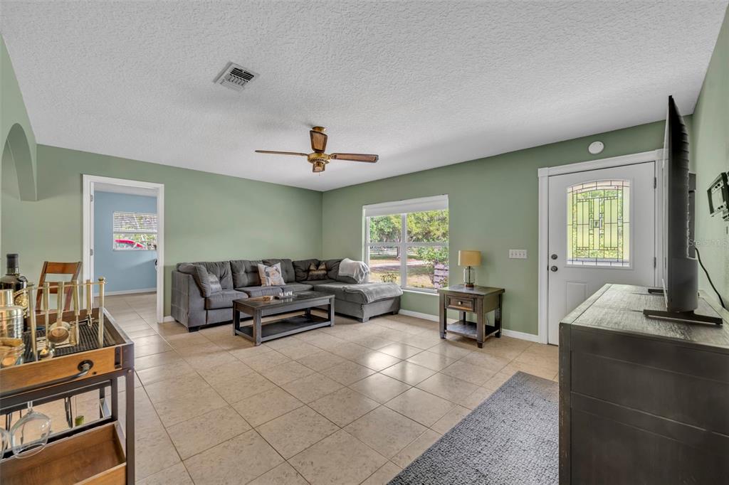430 Cypress Isles Road Osteen, FL 32764 - Photo 7 of 55 a living room with furniture and a window