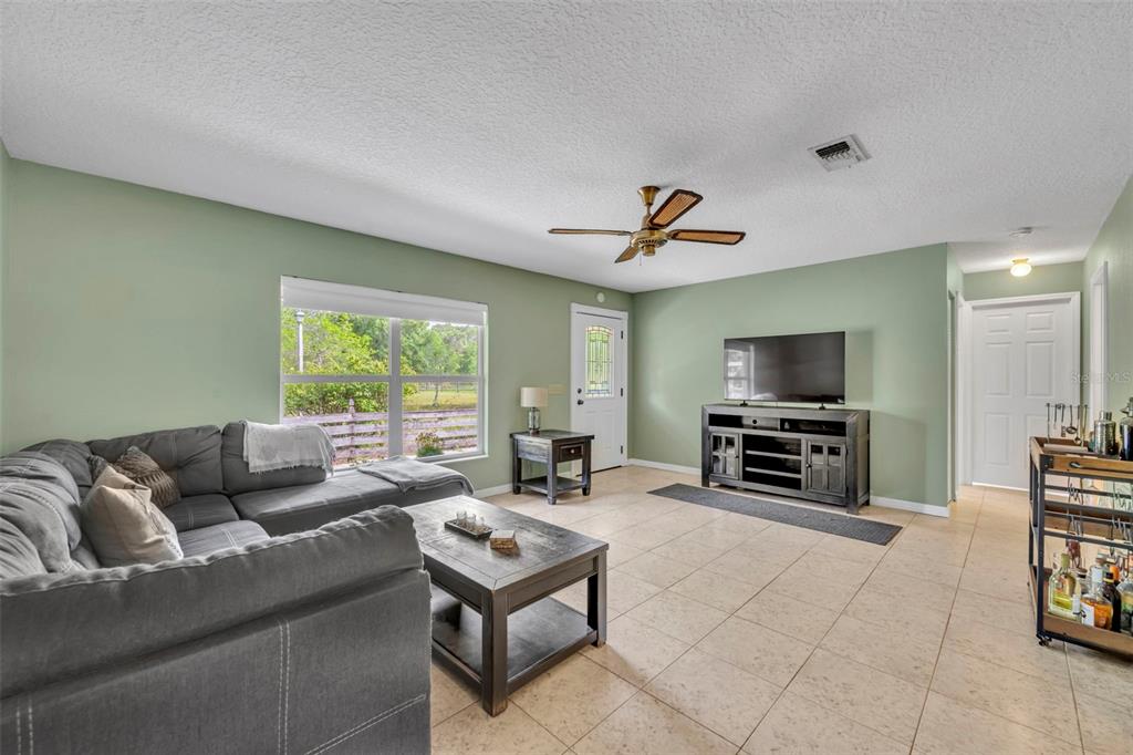 430 Cypress Isles Road Osteen, FL 32764 - Photo 8 of 55 a living room with furniture and a flat screen tv