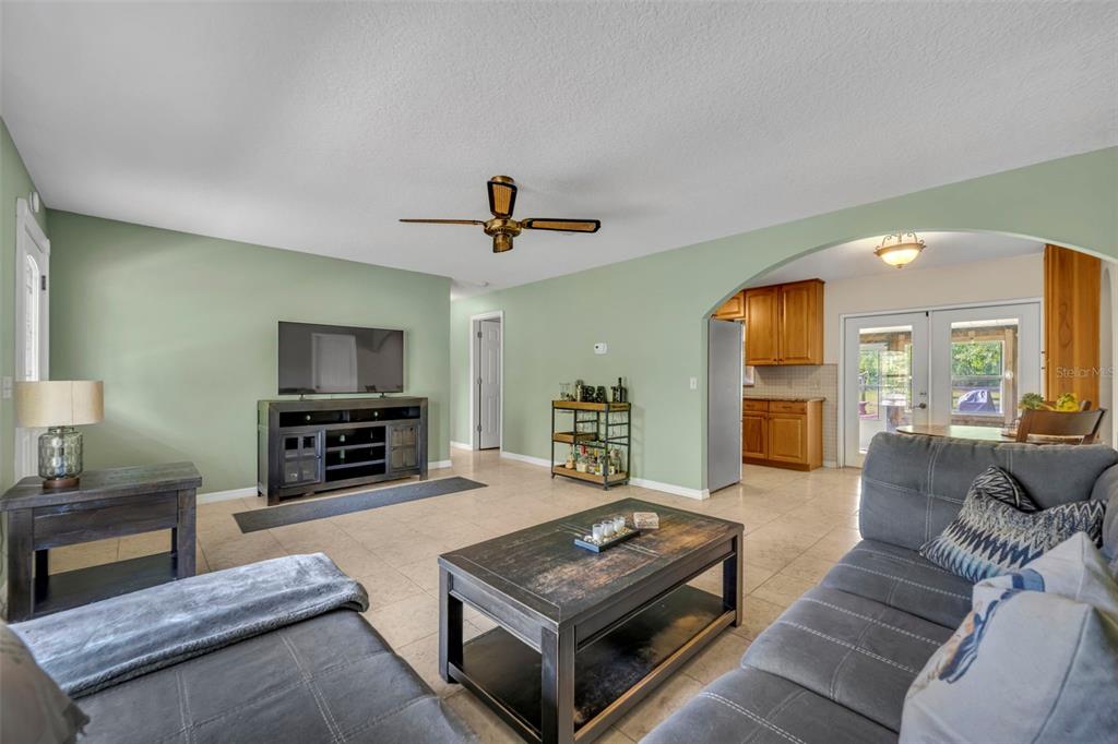 430 Cypress Isles Road Osteen, FL 32764 - Photo 9 of 55 a living room with furniture a flat screen tv and a fireplace
