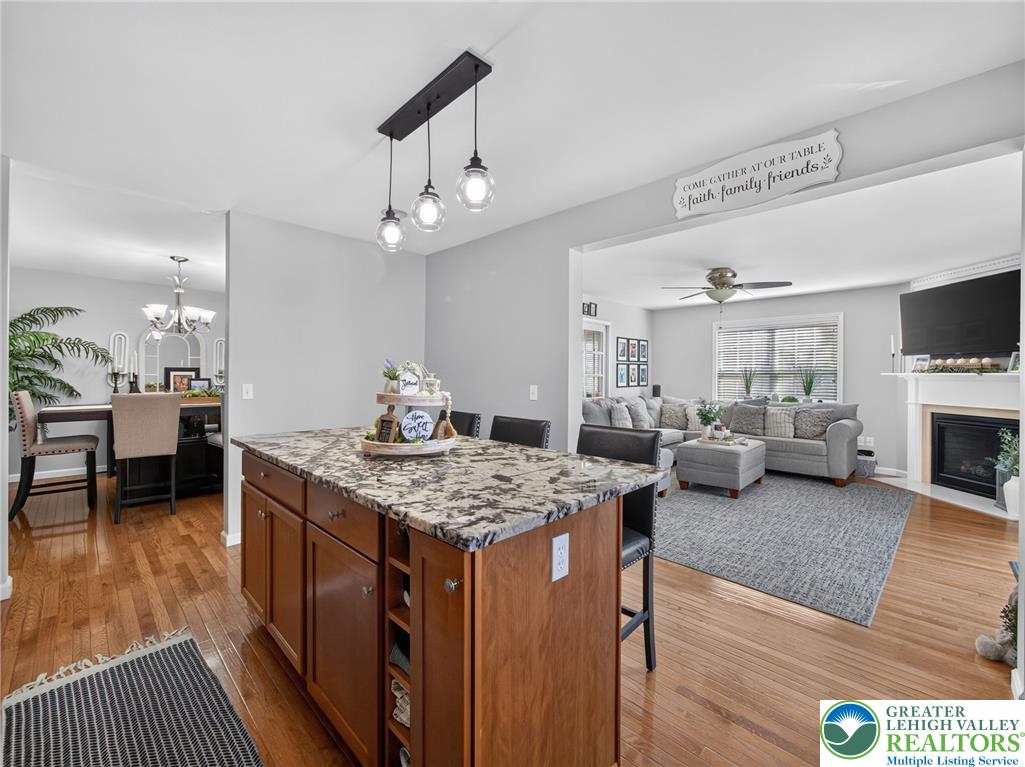 4148 Ross Road Bethlehem, PA 18020 - Photo 39 of 67 A central kitchen island featuring a granite countertop anchors this welcoming open-concept living space.
