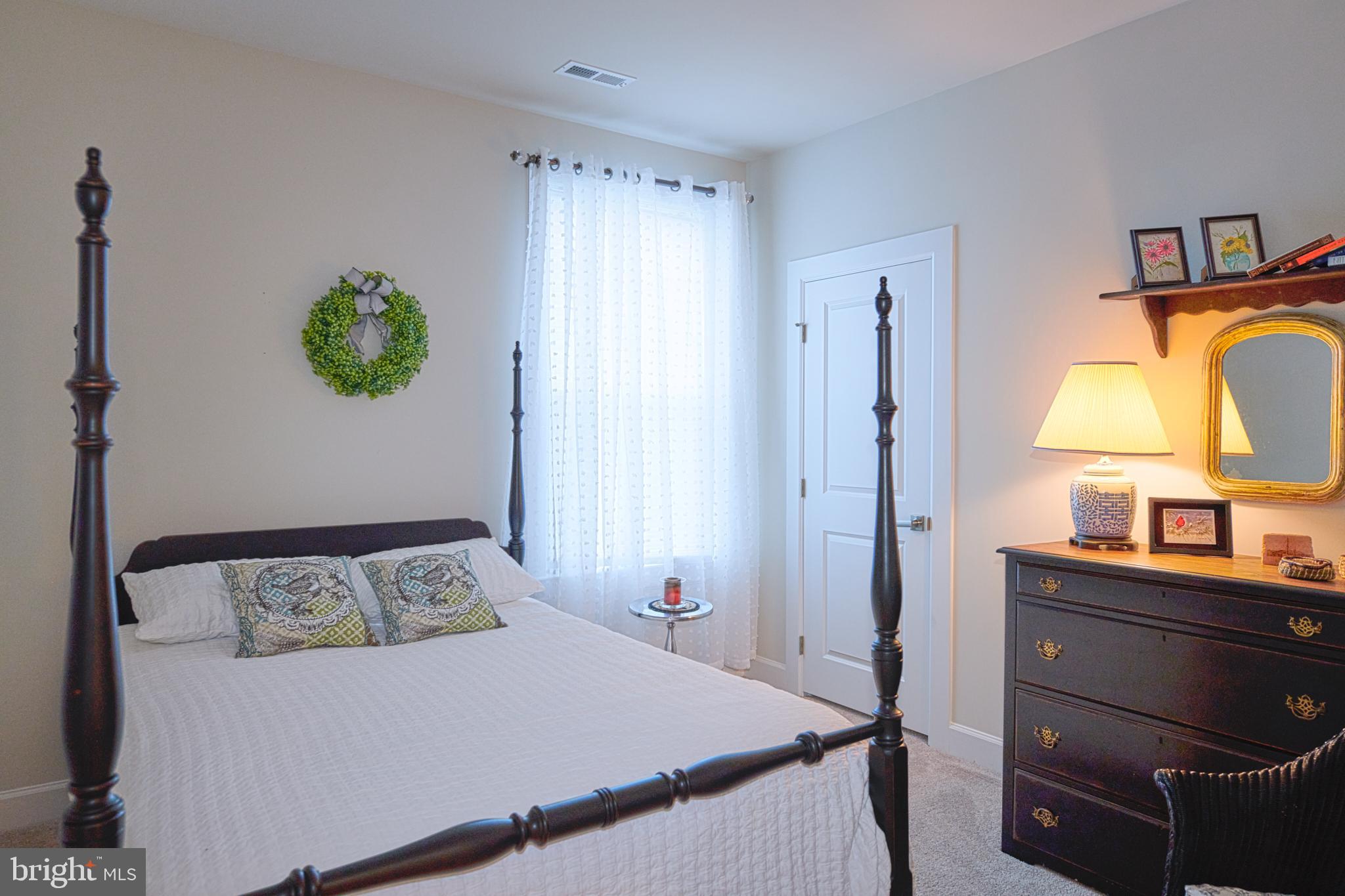 33173 Ponte Vecchio Plaza Ocean View, DE 19970 - Photo 12 of 19 a bedroom with a bed and a dresser