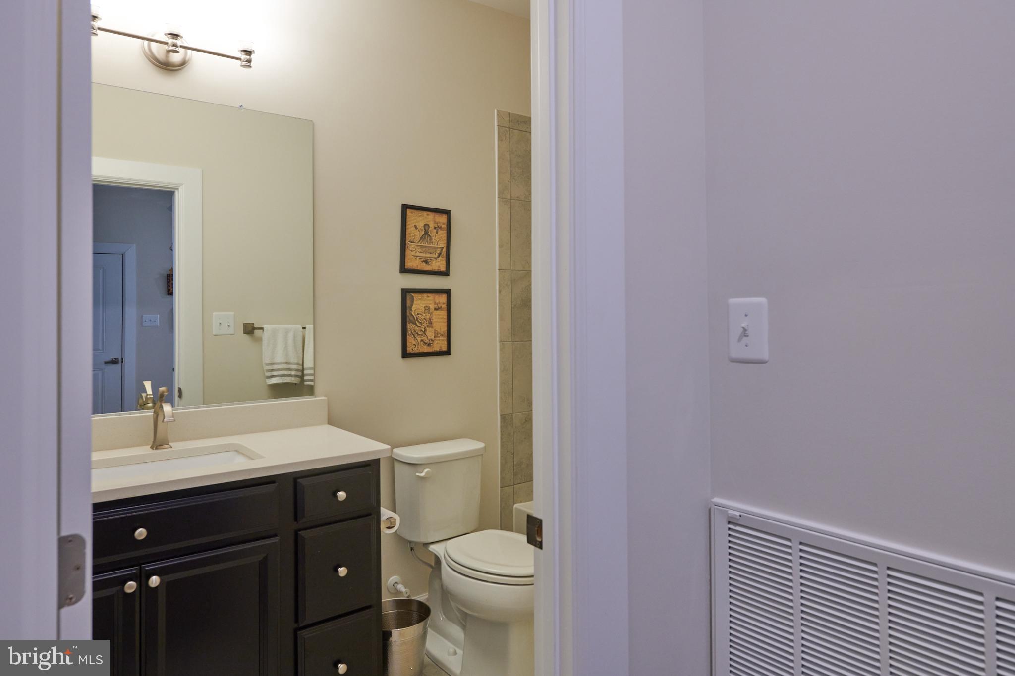 33173 Ponte Vecchio Plaza Ocean View, DE 19970 - Photo 13 of 19 a bathroom with a sink a toilet and a mirror