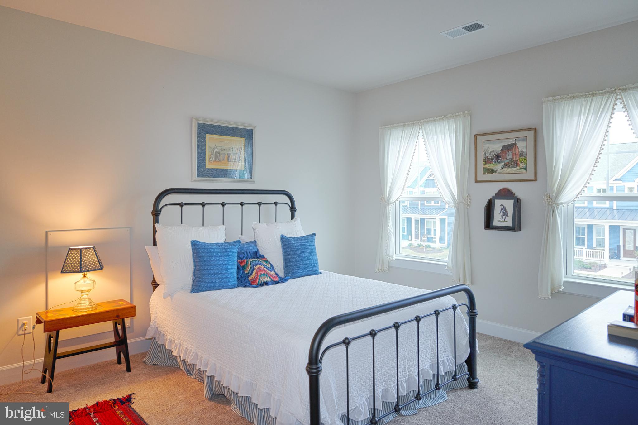 33173 Ponte Vecchio Plaza Ocean View, DE 19970 - Photo 15 of 19 a bedroom with a bed a mirror and a window