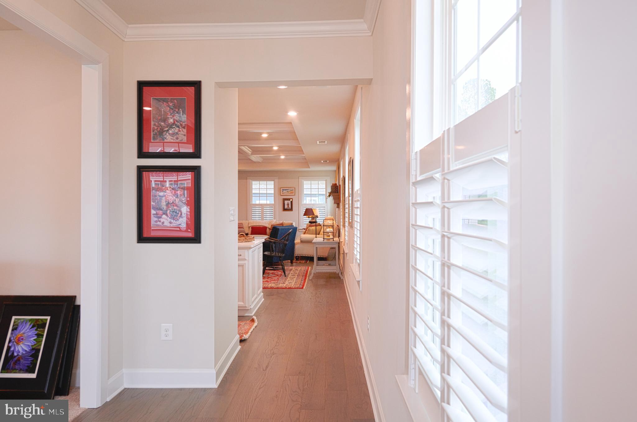 33173 Ponte Vecchio Plaza Ocean View, DE 19970 - Photo 10 of 19 a view of a hallway with wooden floor and windows