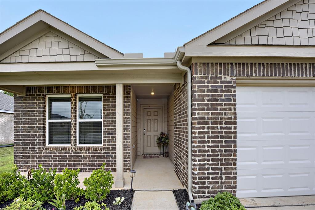 420 Jameson Springtown, TX 76082 - Photo 3 of 29 a view of brick house with potted plants