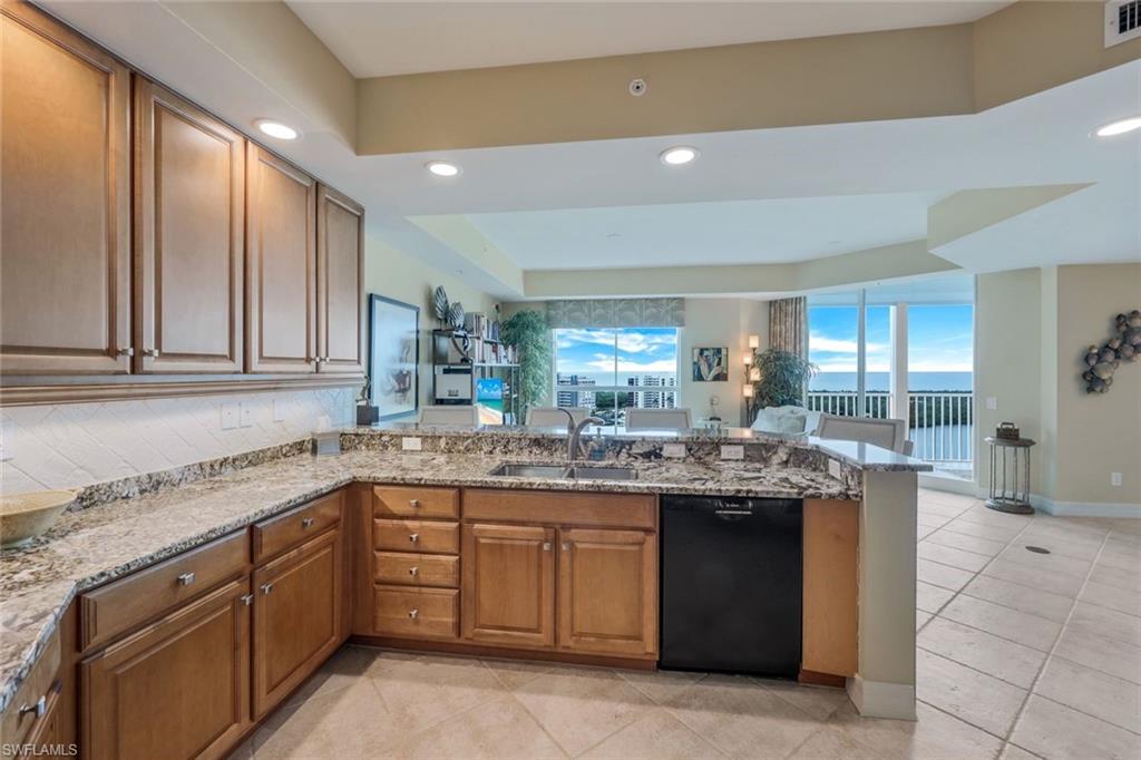 295 Grande Way, Unit 1202 Naples, FL 34110 - Photo 10 of 36 a kitchen with a sink and cabinets