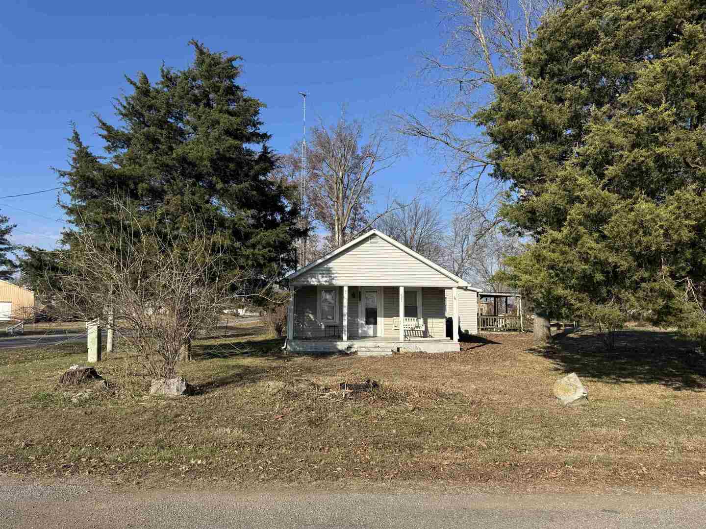 104 Malone Street Sims, IL 62886 - Photo 11 of 13 a patio with a table and chairs under an umbrella