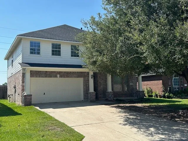 a front view of a house with a yard and a garage