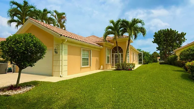 a view of a house with a yard and plants