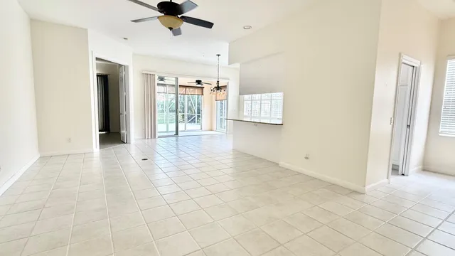 a view of a livingroom with wooden floor and a ceiling fan