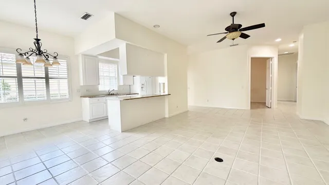 a view of a kitchen with wooden floor and a ceiling fan