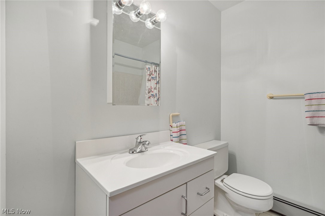 1762 Stonehaven Road Madison, OH 44057 - Photo 18 of 36 Bathroom featuring a baseboard radiator, vanity, and toilet