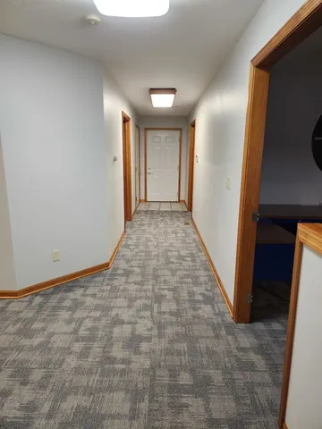 a view of hallway with stairs and a window