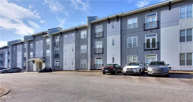 a couple of cars parked in front of building