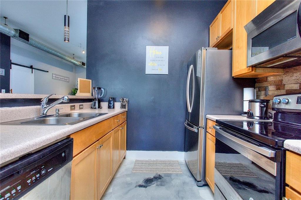 502 Pryor Street Southwest Atlanta, GA 30312 - Photo 11 of 21 a kitchen with stainless steel appliances granite countertop a sink stove and refrigerator