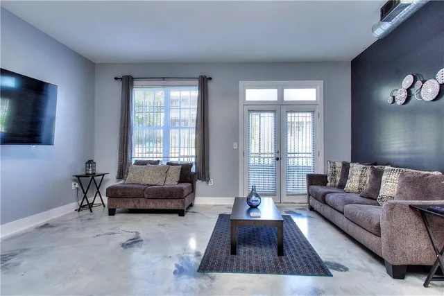 a living room with furniture and a chandelier