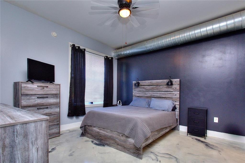 502 Pryor Street Southwest Atlanta, GA 30312 - Photo 16 of 21 a bedroom with a bed and tv