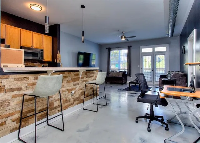 a kitchen with kitchen island counter top space cabinets and appliances