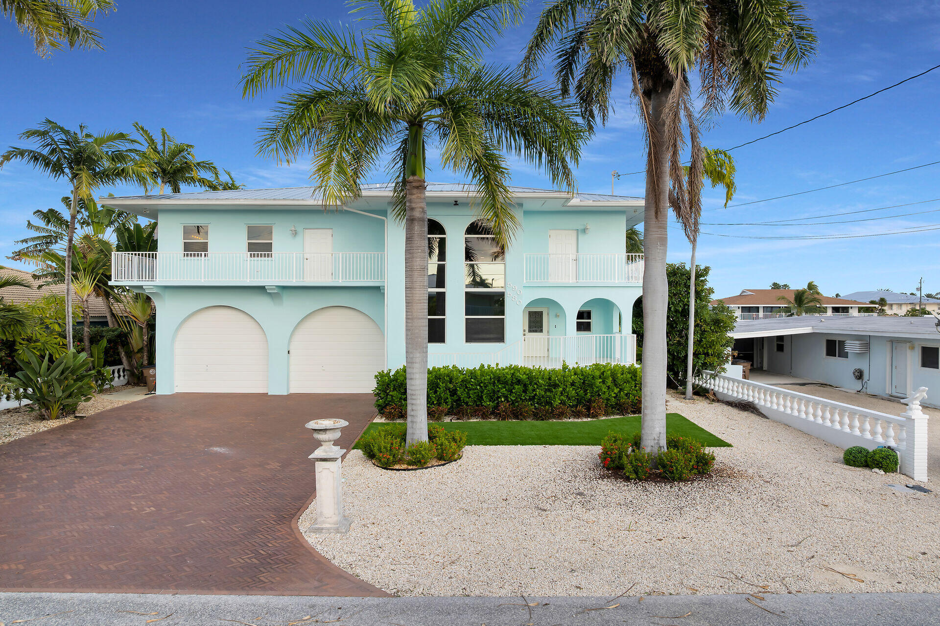 580-590 10th Street Key Colony Beach, FL 33051 - Photo 3 of 75 a front view of a house with a garden