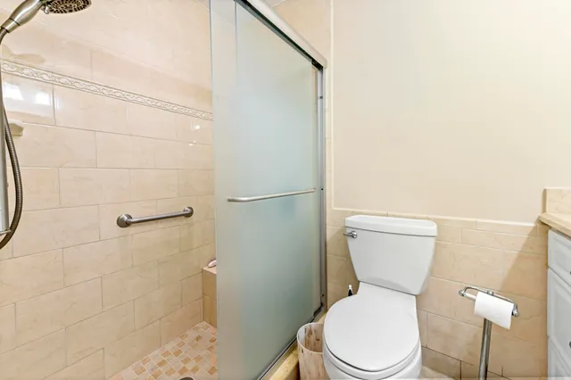a white toilet sitting next to a bathroom sink