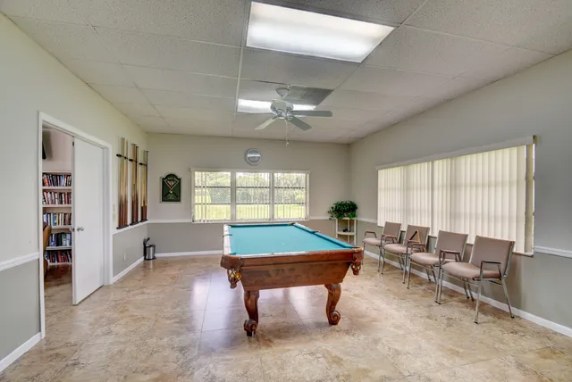 a room with furniture pool table and flat screen tv