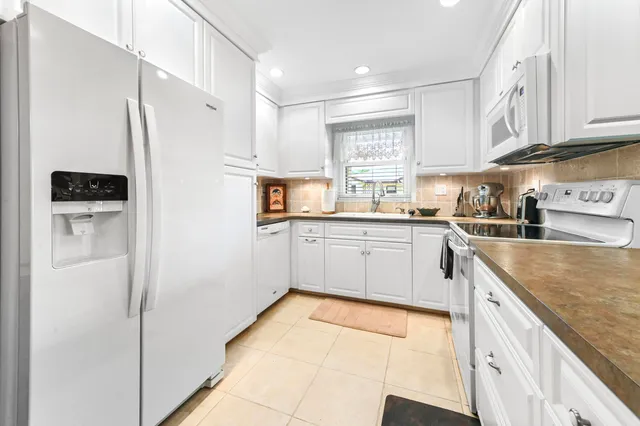 a kitchen with stainless steel appliances a refrigerator sink and cabinets