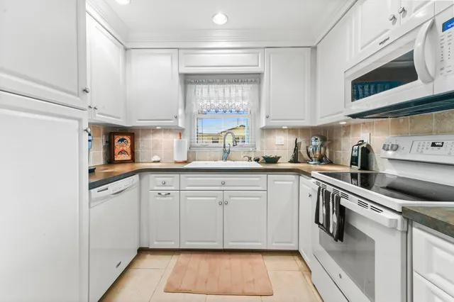 a kitchen with stainless steel appliances granite countertop a sink and cabinets