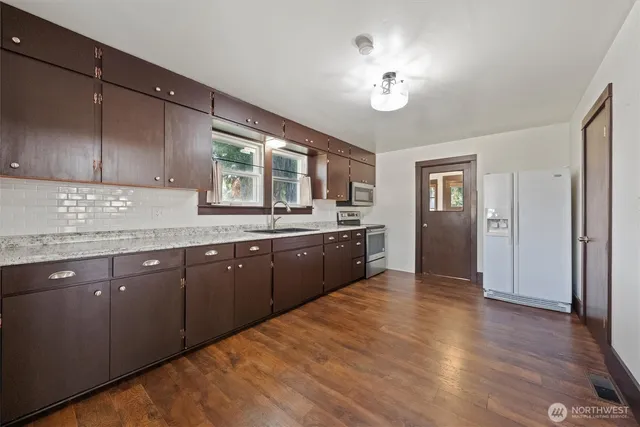 a kitchen with a sink cabinets and window