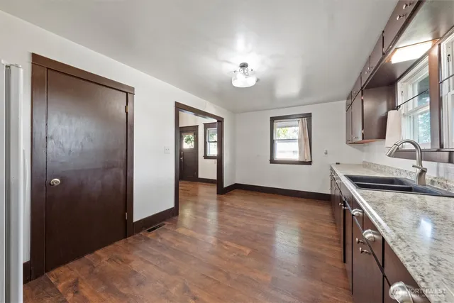 a view of a kitchen cabinets a sink and wooden floor