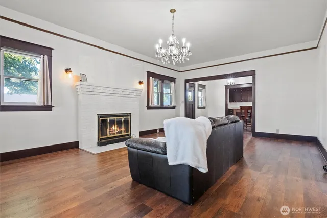 a living room with furniture and a chandelier