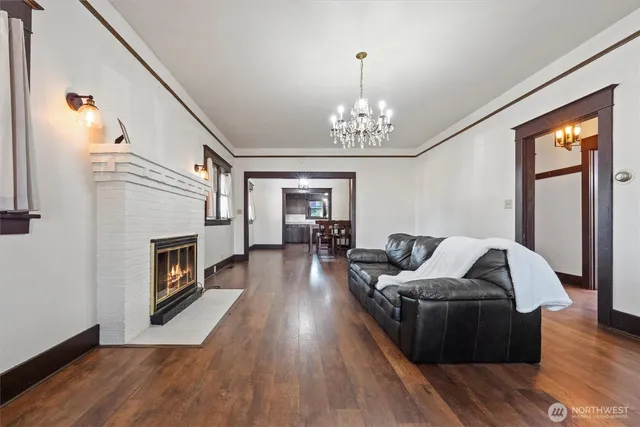 a living room with furniture wooden floor and a fireplace