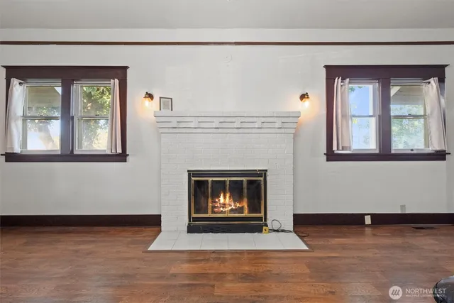 a living room with a fireplace and a floor to ceiling window