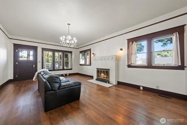 a living room with furniture fireplace and window