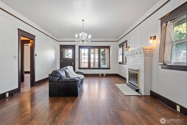 a living room with fireplace furniture and a wooden floor