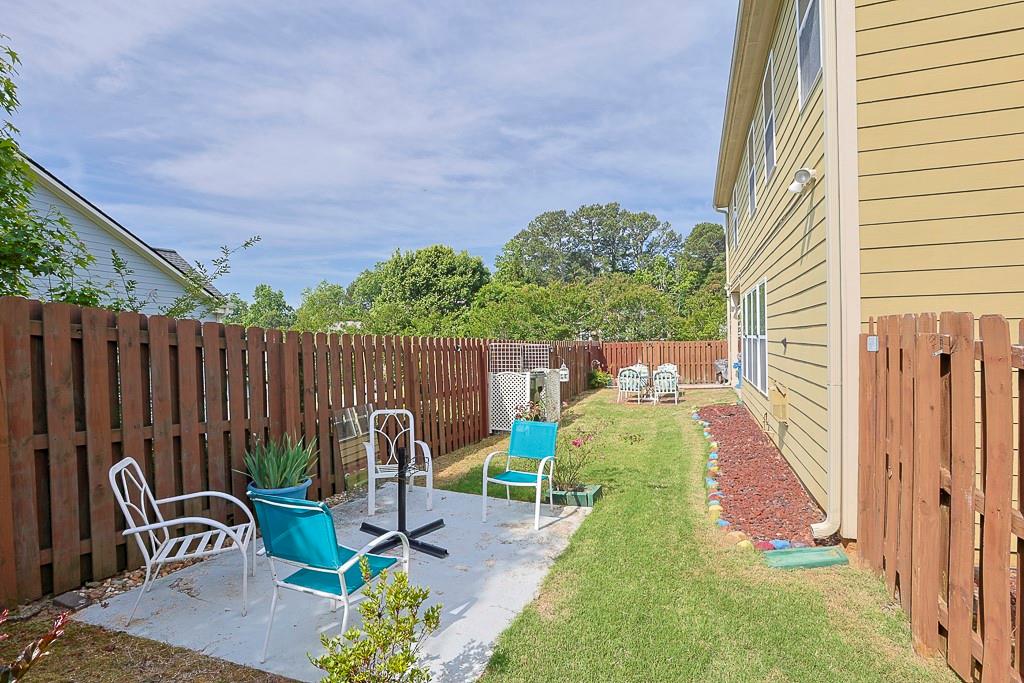 300 Hampton Place Canton, GA 30115 - Photo 69 of 82 a view of a backyard with chairs potted plants and wooden fence