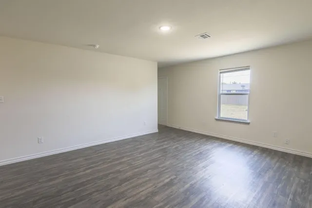 a kitchen with stainless steel appliances granite countertop a sink stove microwave and refrigerator