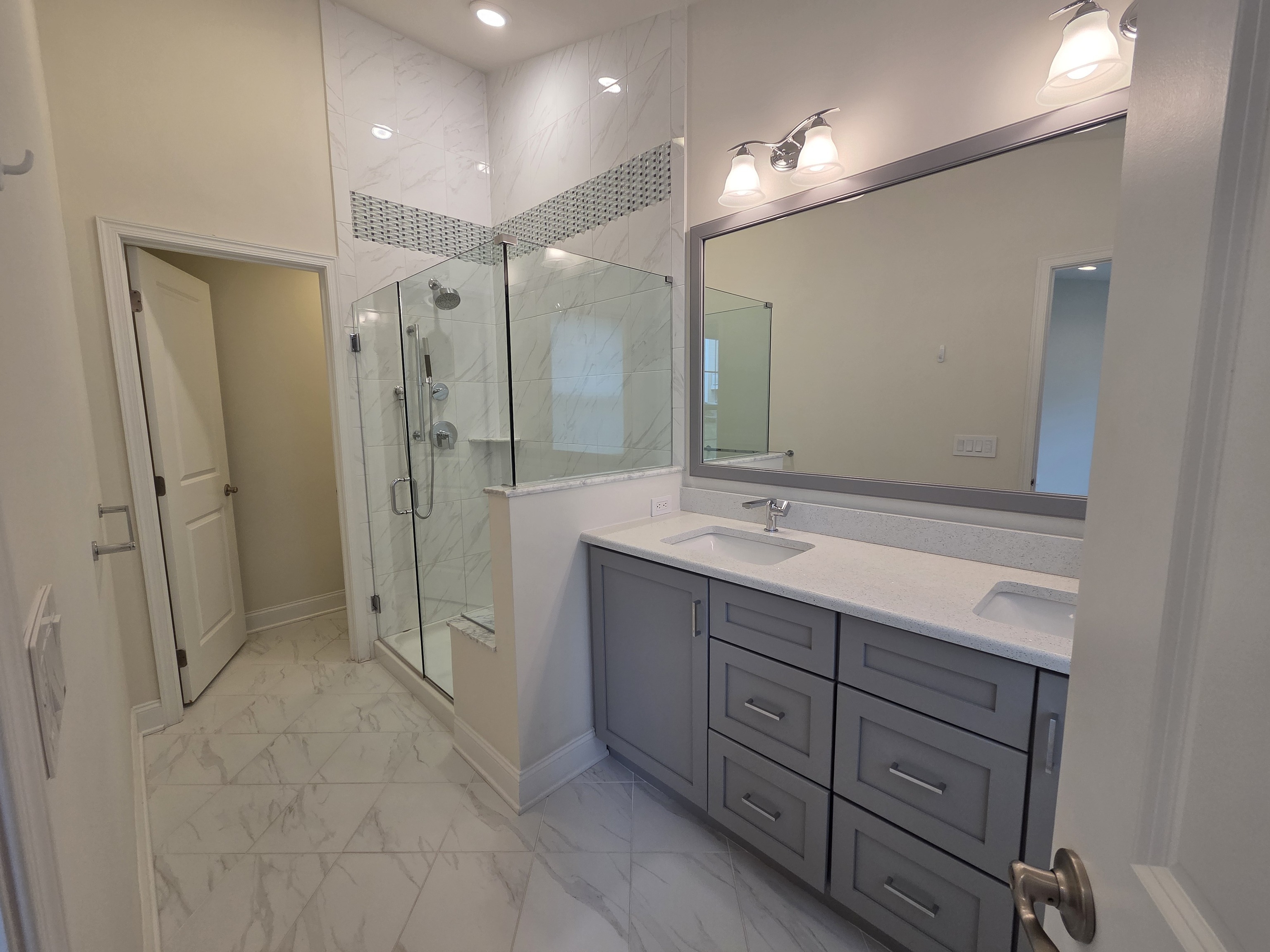 12 Putnam Lane Danbury, CT 06810 - Photo 23 of 33 a bathroom with a shower sink double vanity and mirror