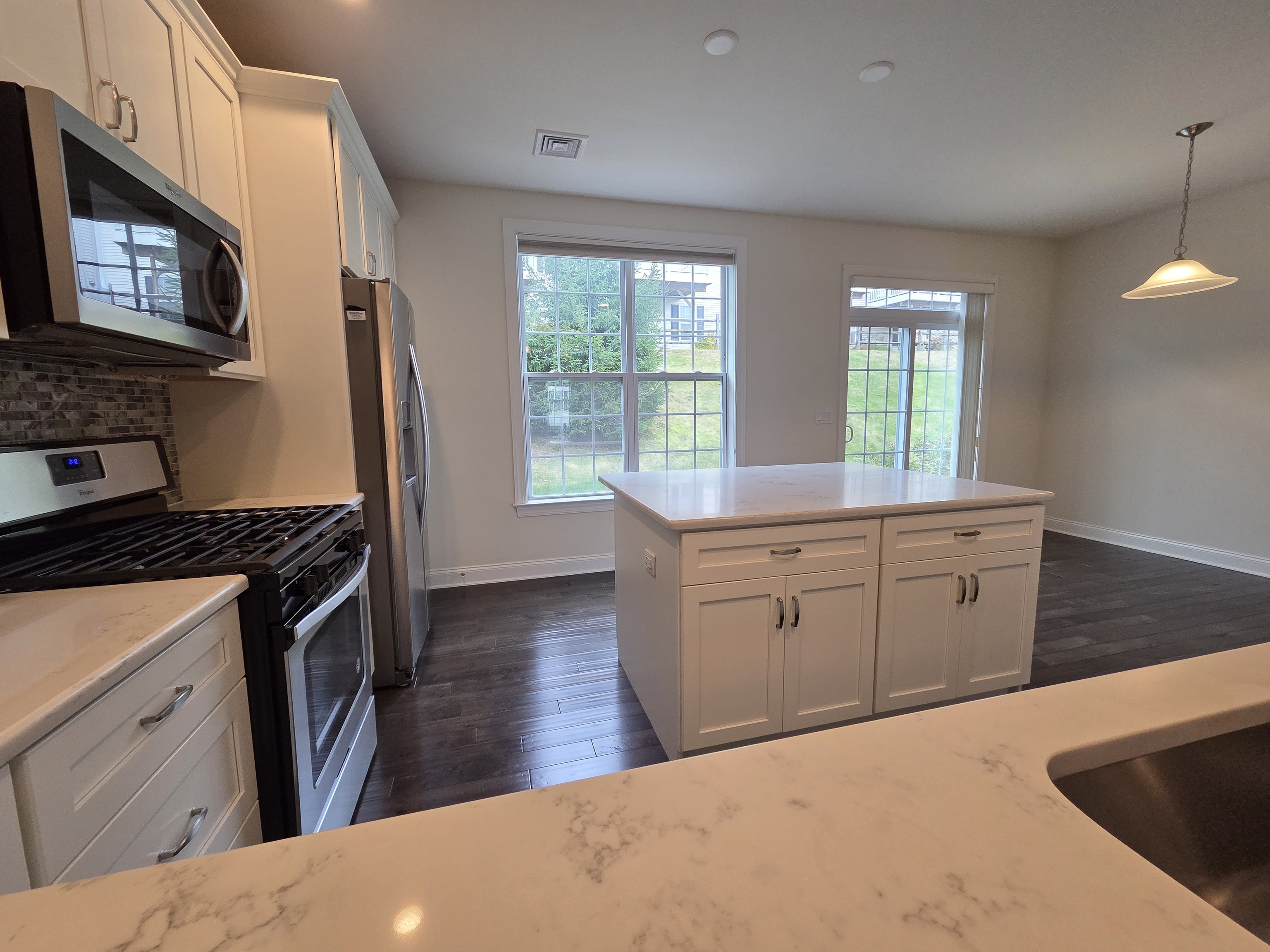 12 Putnam Lane Danbury, CT 06810 - Photo 4 of 33 a kitchen with white cabinets and appliances