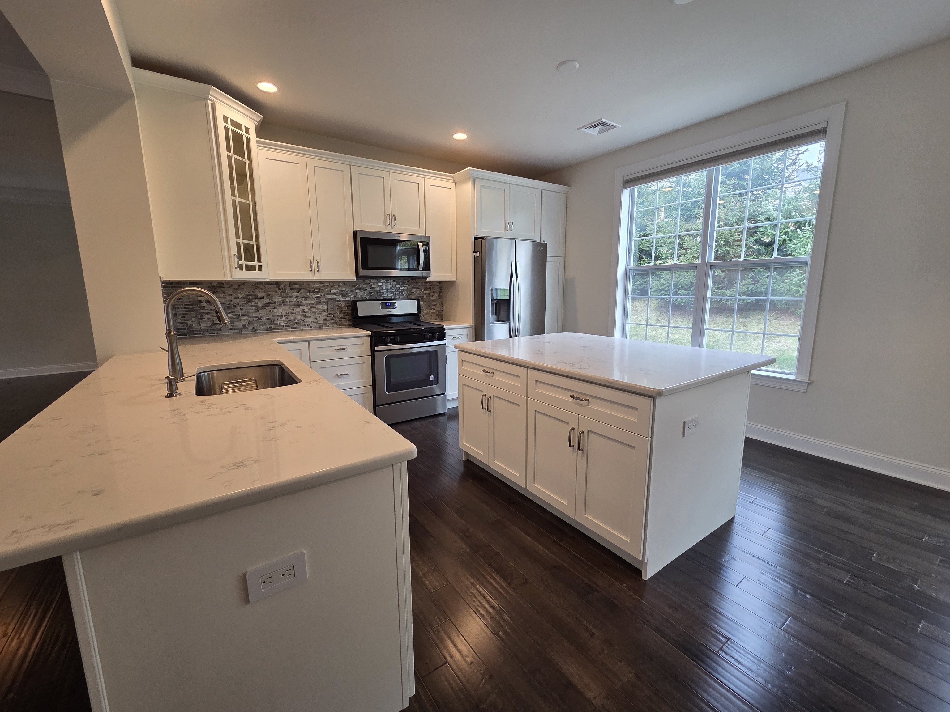 12 Putnam Lane Danbury, CT 06810 - Photo 8 of 33 a kitchen that has a sink a stove top oven a counter space and a window