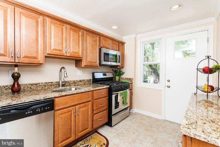 5540 Silverbell Road Baltimore, MD 21206 - Photo 12 of 30 a kitchen with granite countertop a sink stainless steel appliances and cabinets