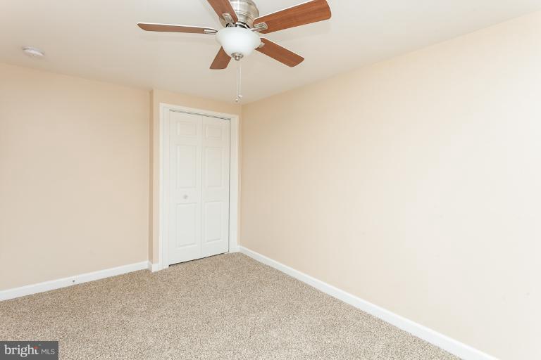 5540 Silverbell Road Baltimore, MD 21206 - Photo 13 of 30 an empty room with a window and a fan