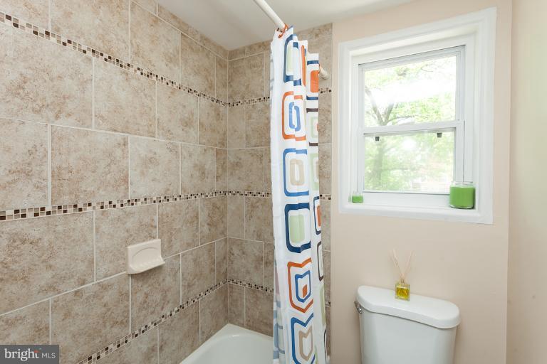 5540 Silverbell Road Baltimore, MD 21206 - Photo 14 of 30 a bathroom with a shower and a toilet