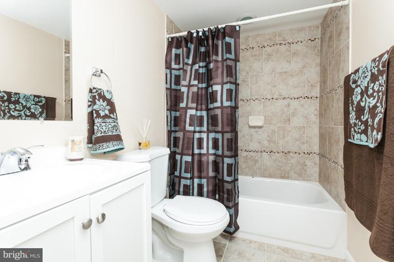 5540 Silverbell Road Baltimore, MD 21206 - Photo 16 of 30 a bathroom with a sink toilet and shower