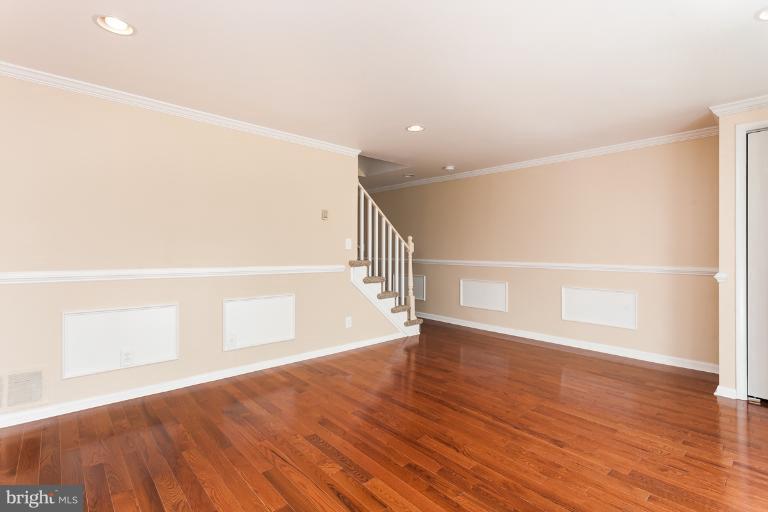 5540 Silverbell Road Baltimore, MD 21206 - Photo 18 of 30 a view of an empty room with wooden floor