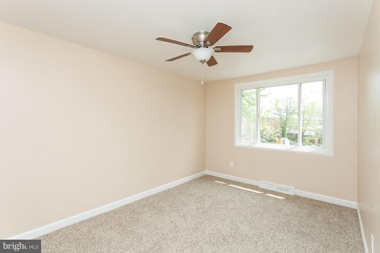 5540 Silverbell Road Baltimore, MD 21206 - Photo 20 of 30 an empty room with a window and a fan