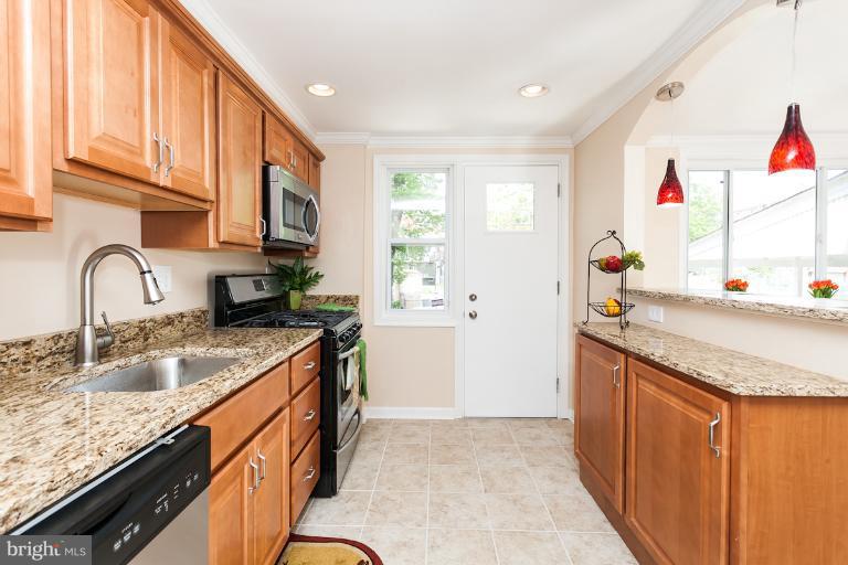 5540 Silverbell Road Baltimore, MD 21206 - Photo 21 of 30 a kitchen with granite countertop a sink and cabinets