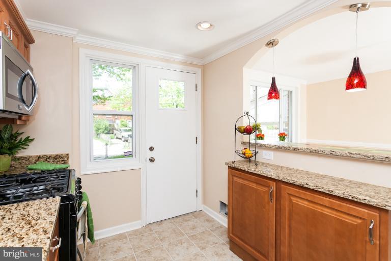 5540 Silverbell Road Baltimore, MD 21206 - Photo 23 of 30 a hallway with window wooden floor and cabinets